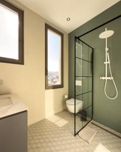 a bathroom with a toilet and a glass shower at Continental Apartment Unirii in Cluj-Napoca