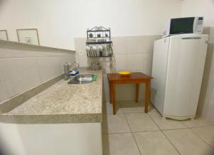 Casa no centro histórico de São João del- Rei في ساو جواو ديل ري: مطبخ صغير مع ثلاجة وطاولة