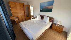 a bedroom with a bed and a table with a chair at Apartments Potz in Illmitz