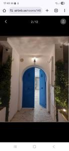 a blue door in a room with a hallway at Farah in Sousse