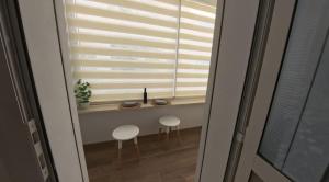 a window with two stools in front of it at Farah in Sousse