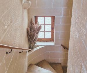 a stone staircase with a window in a bathroom at Sunset Castle House with Pool in Xagħra +27 photos