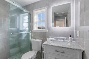 a bathroom with a shower and a toilet and a sink at @ Marbella Lane - Buckingham Place Laundry + P in Pacifica +32 photos