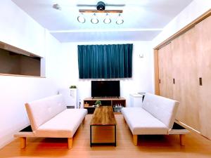 a living room with two chairs and a coffee table at Excel 中島公園 -FIX HOME- in Sapporo