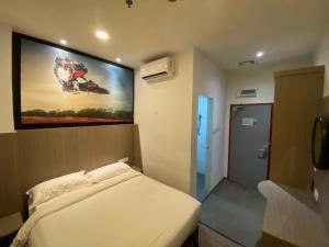 Ένα ή περισσότερα κρεβάτια σε δωμάτιο στο Arafah Hotel