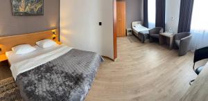 a hotel room with a bed and two chairs at Hotel Complex Ukraine in Lutsk +51 photos