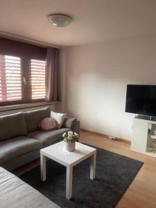 a living room with a couch and a table at Apartamento en el centro de rorschach in Rorschach