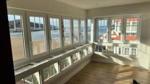 a large room with windows and a view of the beach at LAIDA BEACH by Urdaibai Experience in Ibarrangelu