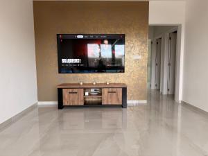 a living room with a flat screen tv on a wall at Skyline WIFI Parking - Confort in Brussels