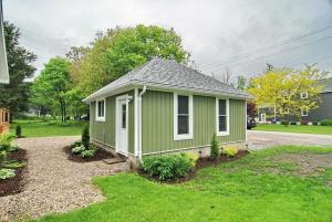 a green tiny house on the side of a street at Shores of Erie Guest House in Essex