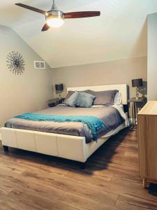 a bedroom with a large bed with a ceiling fan at Shores of Erie Guest House in Essex