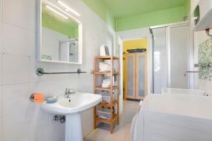 a bathroom with a sink and a toilet and a tub at Da Roby - Villa Carolina in Fenis +17 photos