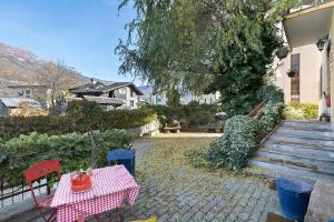 a table and two chairs with a table at Da Roby - Villa Carolina in Fenis