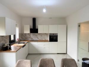 a kitchen with white cabinets and a counter top at Skyline WIFI Parking - Confort in Brussels