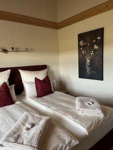 a bedroom with two beds and a deer picture on the wall at Ferienhaus Fichtelwichtel in Mehlmeisel
