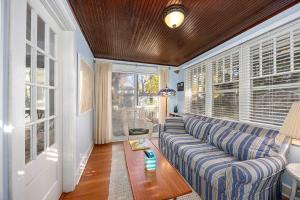 a living room with a blue couch and windows at Charming Saugatuck Getaway by Lake & Shops in Saugatuck