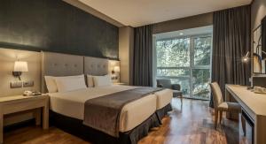 Ένα ή περισσότερα κρεβάτια σε δωμάτιο στο Ilunion Pio XII