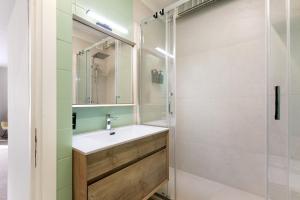 a bathroom with a sink and a shower at Ma Chérie-Lumière in Pila +24 photos