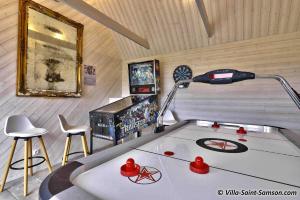 a room with a ping pong table and a lamp at Villa Saint Samson in Trégastel +19 photos