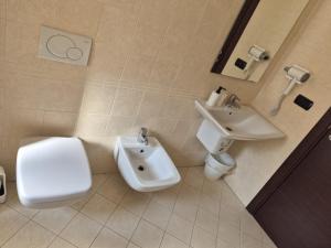 a bathroom with a sink and a toilet and a bidet at mirosa airport home in Macchie +16 photos