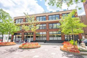 a large brick building with trees in front of it at The 333 Suites 303 - Suite for 6 in Cincinnati