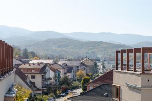 a view of a town with mountains in the background at DolceVita Lux & SPA in Vrnjačka Banja