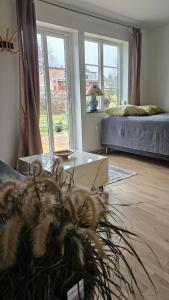 a living room with a glass table and a bed at Studio Borgen in Sigtuna