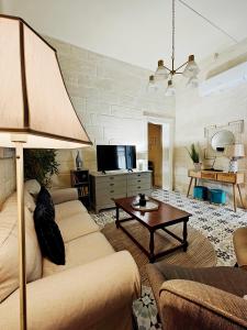 a living room with a couch and a table at Birgu 3 in Cospicua