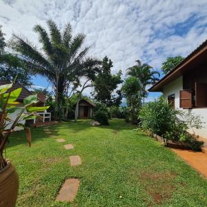 a yard with a house and a palm tree at Clear Water Pool Villa in Mu Si +31 photos