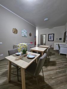 a dining room with two tables and chairs at Dream & Fly Hermada in Fiumicino