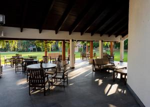 an outdoor patio with tables and chairs and tables and chairs at Ancestral Copan in Copan Ruinas
