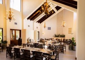 a dining room with tables and chairs and chandeliers at Ancestral Copan in Copan Ruinas