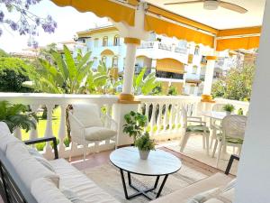 a porch with a couch and a table on a balcony at Marbella - Puerto Banus in Marbella
