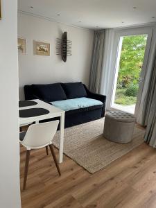 a living room with a couch and a table at Strandgut in Rostock