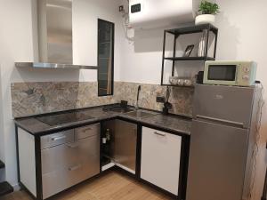 a small kitchen with a sink and a refrigerator at Casa Hegoa in Elgóibar