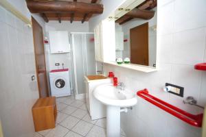 a bathroom with a sink and a washing machine at Guest House Formigine in Formigine +61 photos