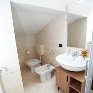 a bathroom with a sink and a toilet at Guest House Onde Chiare in Reggio Emilia