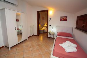 a small bedroom with a bed and a bathroom at Guest House Onde Chiare in Reggio Emilia