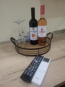 two bottles of wine and a remote control on a table at Angelina's Home and Spa Alexandroupolis in Alexandroupoli +9 photos