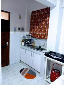 a small kitchen with a sink and a counter at Talla Homes in Mombasa +2 photos
