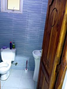 a bathroom with a toilet and a sink at Talla Homes in Mombasa