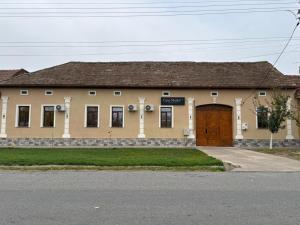 een gebouw met een bruine deur op een straat bij Casa Marko in Nădlac