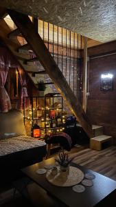 a room with a staircase and a table in a room at Vikendica SD in Ugljevik