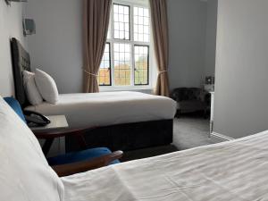 Ένα ή περισσότερα κρεβάτια σε δωμάτιο στο Southcrest Manor Hotel, Best Western Signature Collection