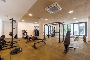 a gym with several treadmills and machines in a room at Apartamentos - Delfin Natura in L'Alfas del Pi