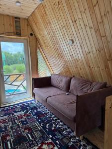 阿克托比Nova nova的窗户房间里一张棕色的沙发