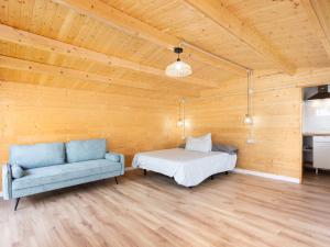 a room with a bed and a couch in it at Live Villa Adrian in Caleta de Interián