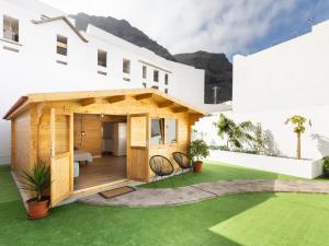 a house with a green lawn in front of it at Live Villa Adrian in Caleta de Interián