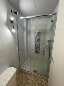 a shower with a glass door in a bathroom at Santa Ana en pleno centro cerca de Sevilla in Alcalá de Guadaira +4 photos