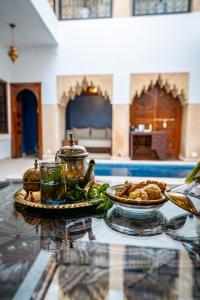 een glazen tafel met een bord eten erop bij Riad Serendip in Marrakesh